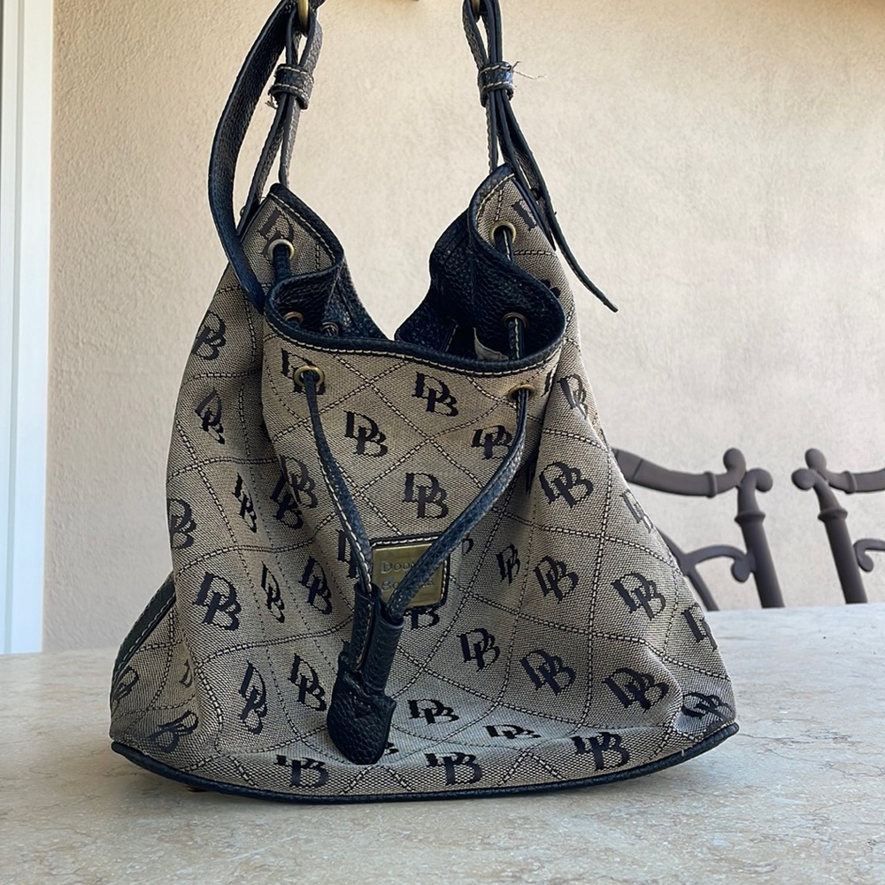Dooney and Bourke, 1975 brown bag with black leather straps